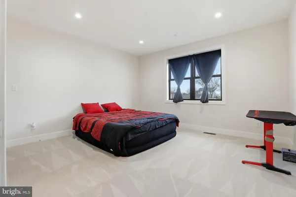 an empty room with wooden floor and entryway