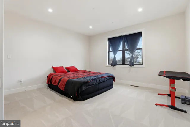 an empty room with wooden floor and entryway