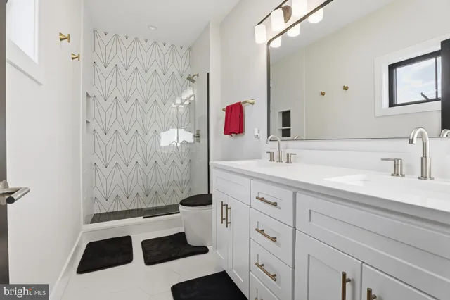 a spacious bedroom with a bed and a wall painting