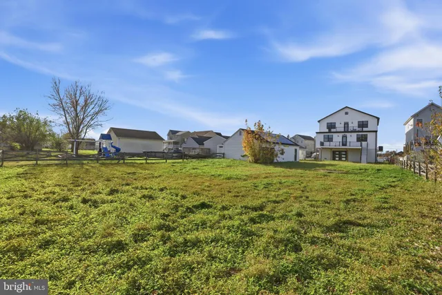 an aerial view of a house with outdoor seating