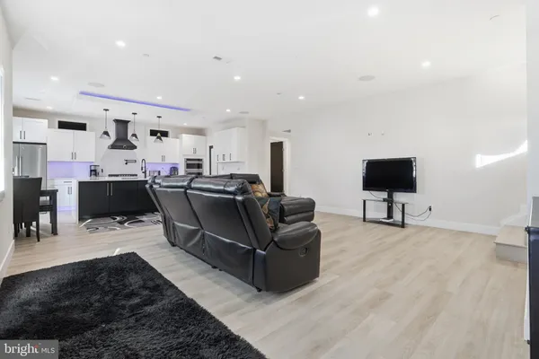 a kitchen with stainless steel appliances kitchen island granite countertop a sink stove and refrigerator