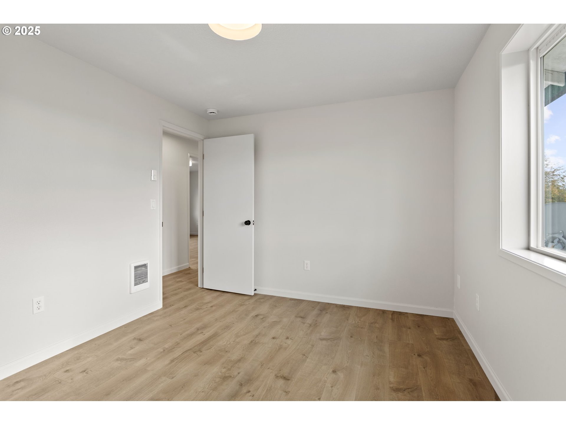16301 Northeast 77th Circle Vancouver, WA 98682 - Photo 33 of 44 a view of an empty room with wooden floor and a window