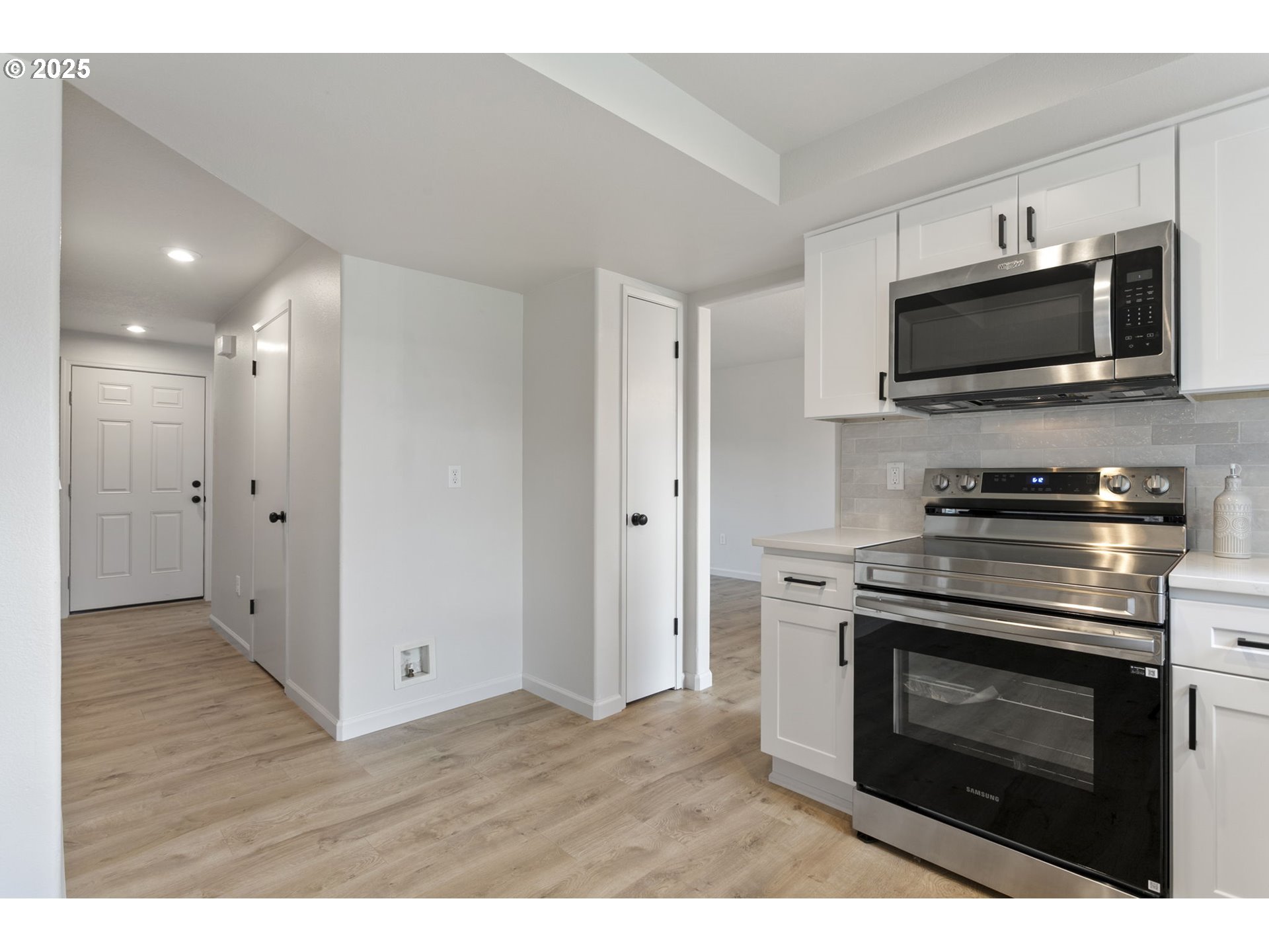 16301 Northeast 77th Circle Vancouver, WA 98682 - Photo 9 of 44 a kitchen with stainless steel appliances a stove a microwave and cabinets