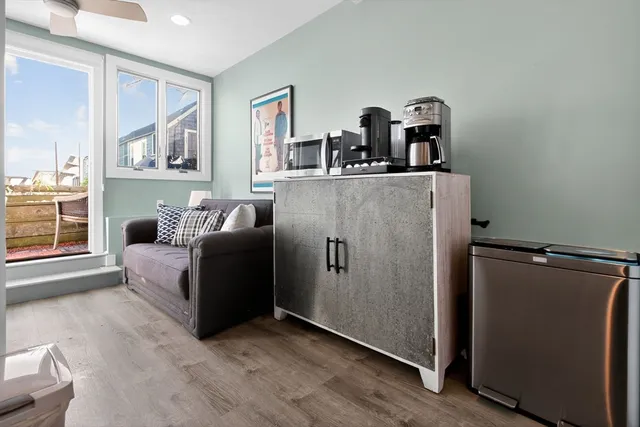 a living room with furniture and a mirror