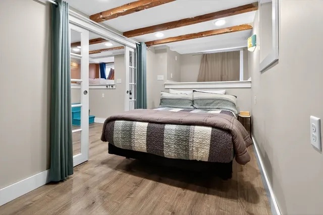 a living room with furniture a rug and a wall painting