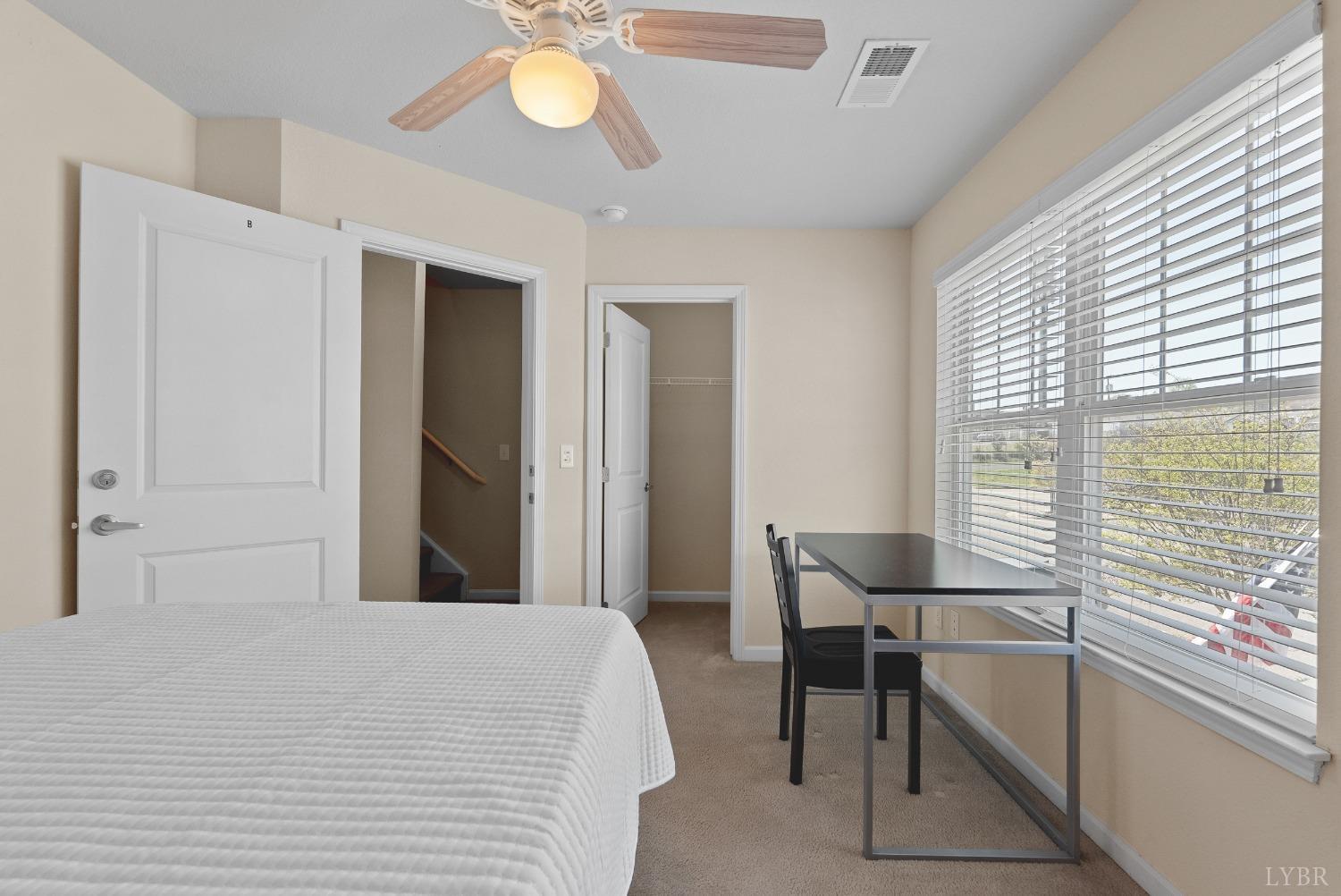 1600 Wards Ferry Road, Unit 907 Lynchburg, VA 24502 - Photo 25 of 53 a bedroom with a bed and a chandelier