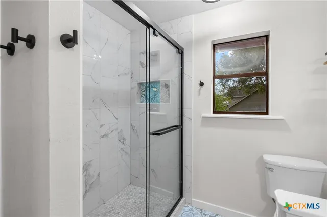 a bathroom with a shower and a toilet