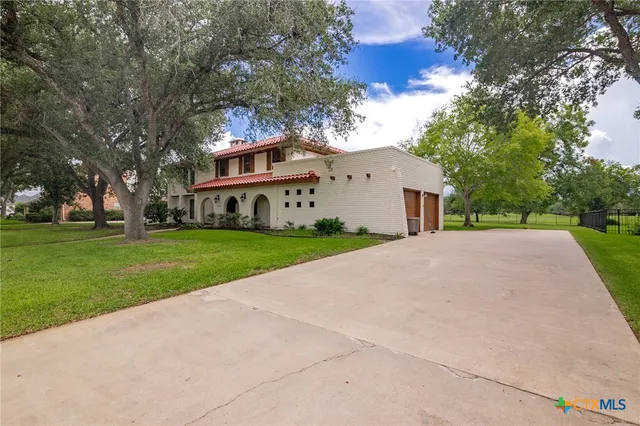 a view of house with yard and green space