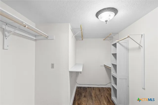 a view of a room with wooden floor and staircase