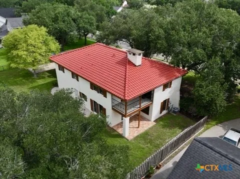 a aerial view of a house with a yard