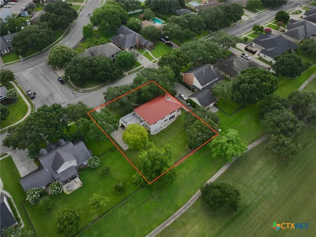 an aerial view of residential houses with outdoor space and swimming pool