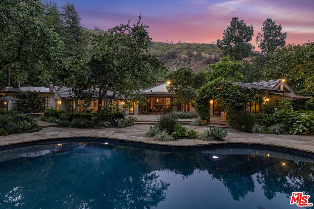 3099 Mandeville Canyon Road Los Angeles, CA 90049 - Photo 11 of 50 a view of a lake with a house in the background
