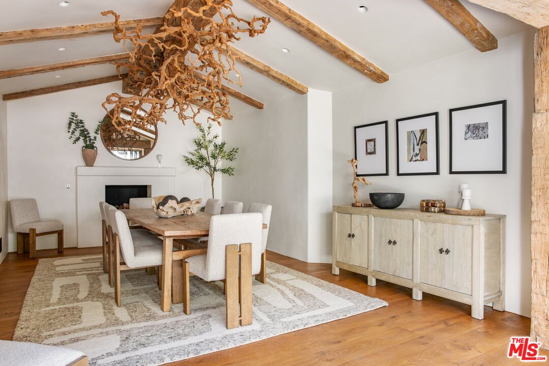 3099 Mandeville Canyon Road Los Angeles, CA 90049 - Photo 18 of 50 a kitchen with stainless steel appliances kitchen island granite countertop a table and chairs in it