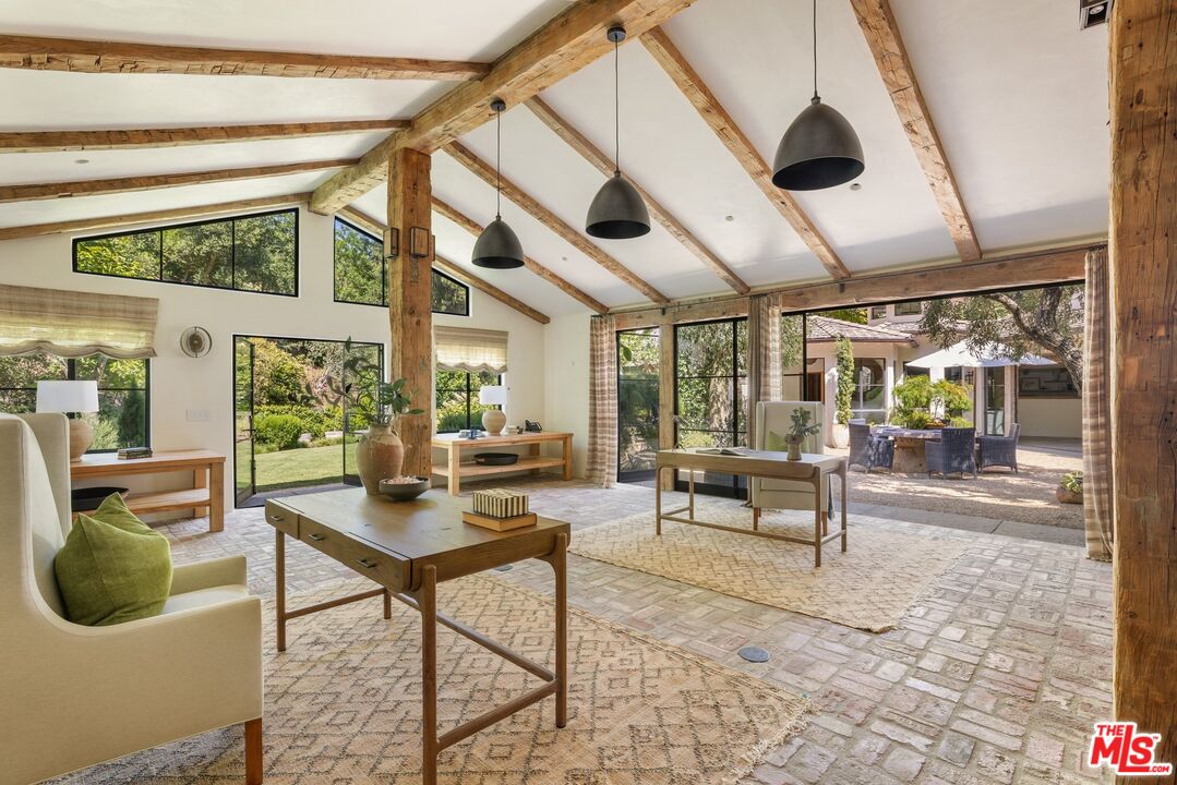3099 Mandeville Canyon Road Los Angeles, CA 90049 - Photo 19 of 50 a living room with furniture and a large window