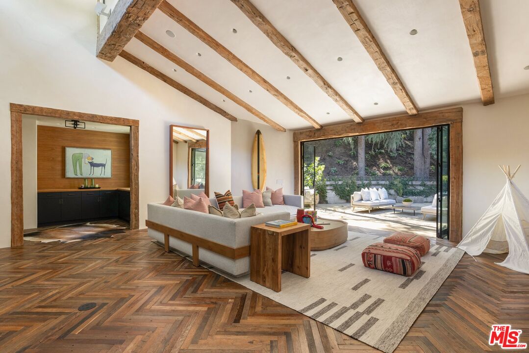 3099 Mandeville Canyon Road Los Angeles, CA 90049 - Photo 20 of 50 a living room with fireplace furniture and a large window