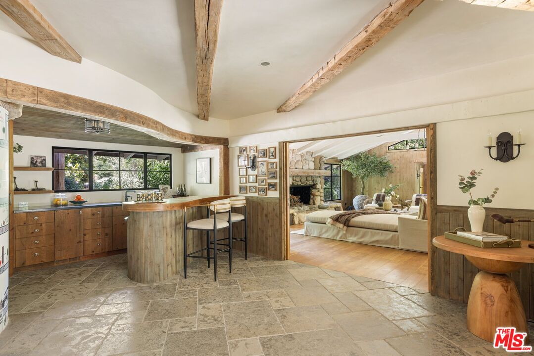 3099 Mandeville Canyon Road Los Angeles, CA 90049 - Photo 25 of 50 a living room with furniture and a large window