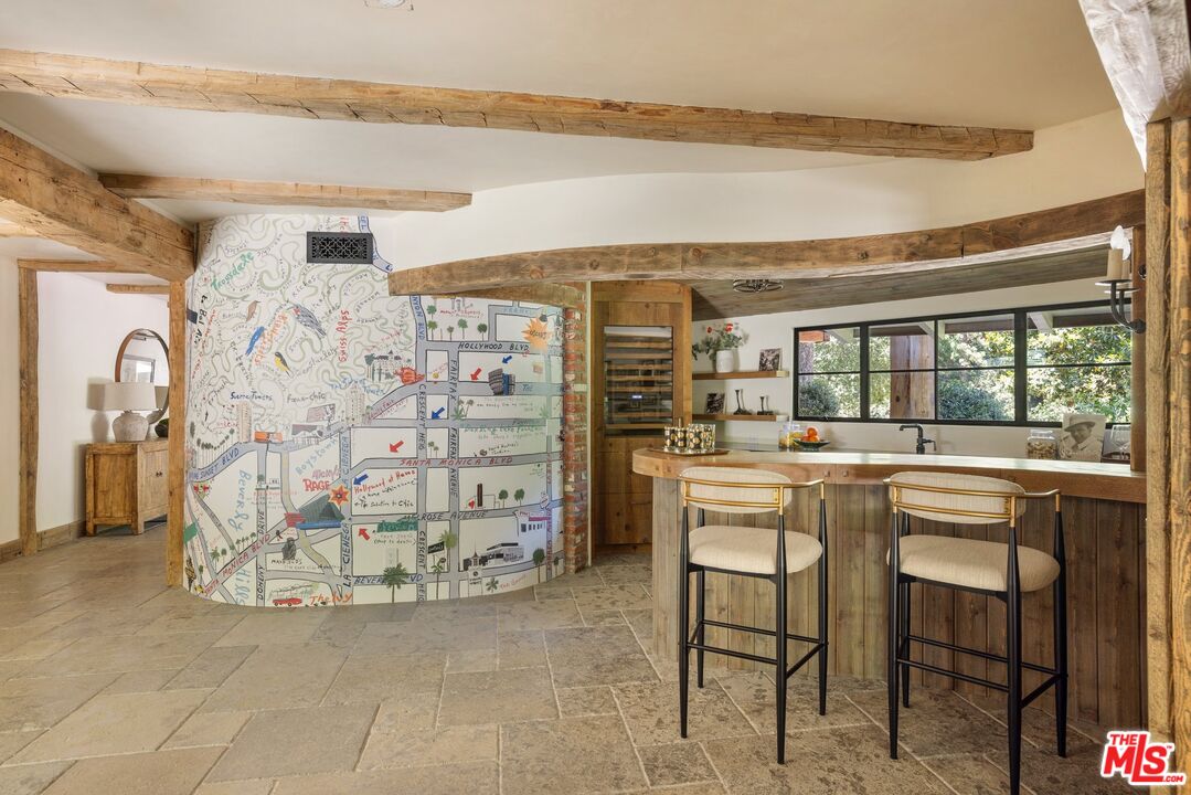 3099 Mandeville Canyon Road Los Angeles, CA 90049 - Photo 26 of 50 a view of a workspace with furniture