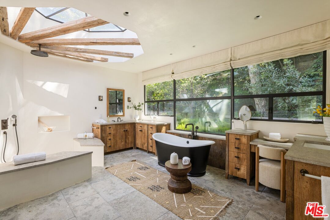 3099 Mandeville Canyon Road Los Angeles, CA 90049 - Photo 31 of 50 a room with furniture a large window and chandelier