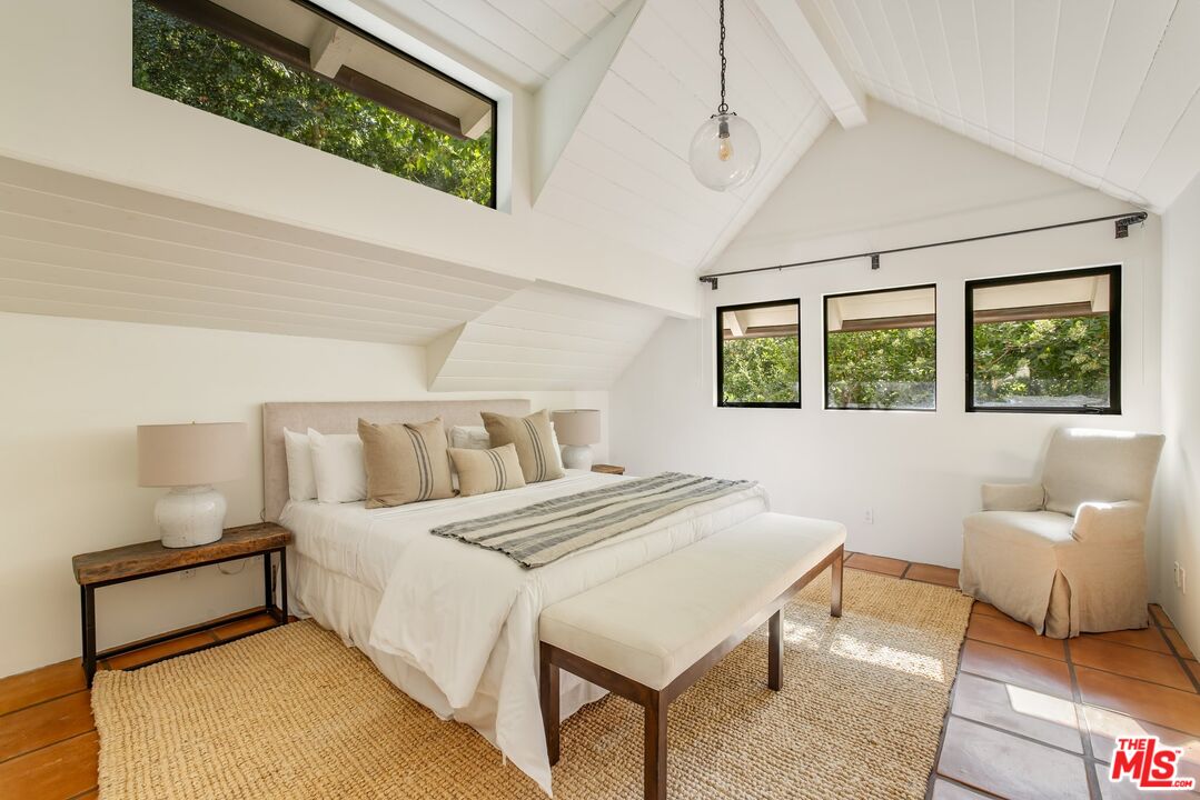 3099 Mandeville Canyon Road Los Angeles, CA 90049 - Photo 41 of 50 a bedroom with a bed and a couch