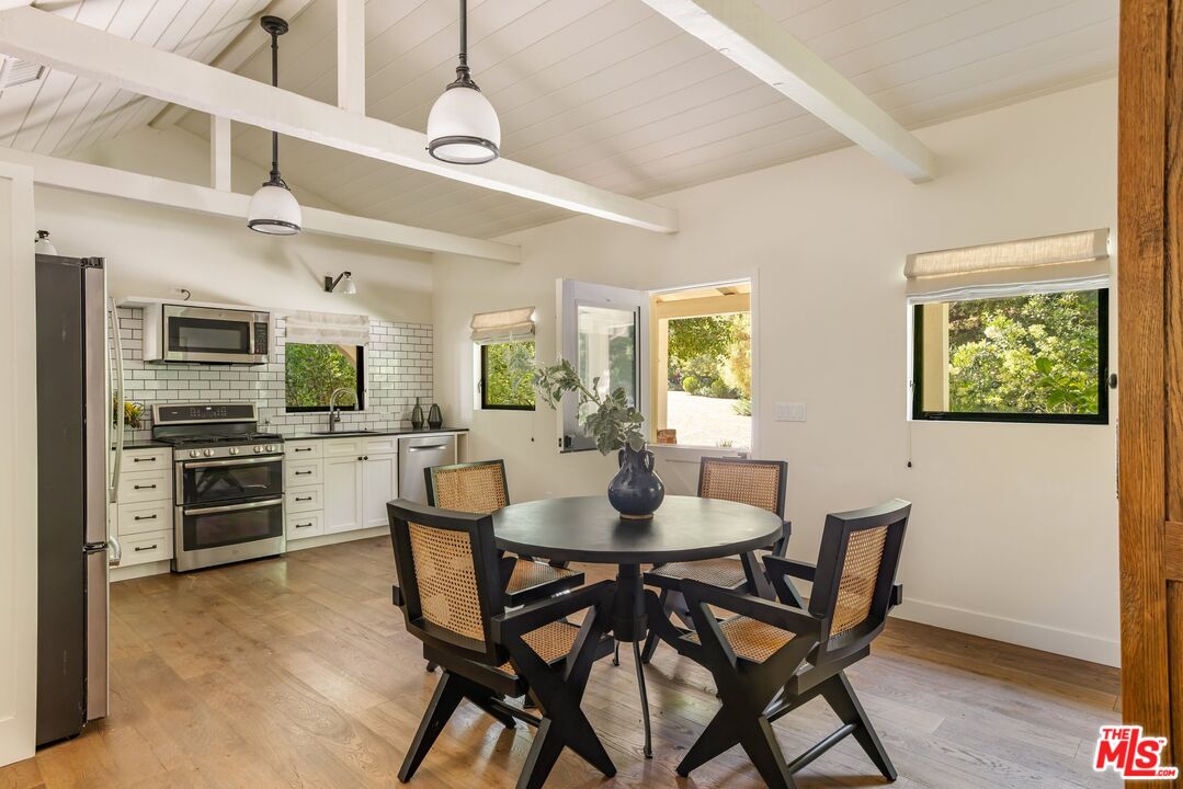 3099 Mandeville Canyon Road Los Angeles, CA 90049 - Photo 42 of 50 a dining room with furniture and window