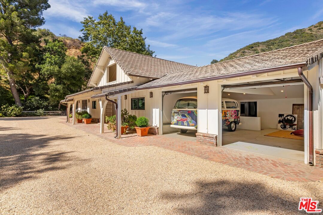 3099 Mandeville Canyon Road Los Angeles, CA 90049 - Photo 44 of 50 a view of a house with outdoor space and porch
