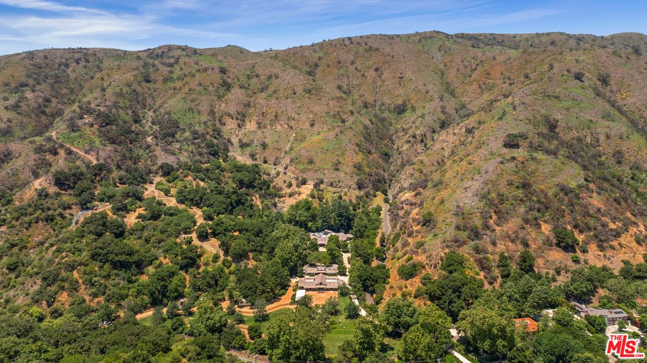 3099 Mandeville Canyon Road Los Angeles, CA 90049 - Photo 49 of 50 a view of a mountain in the distance in a field
