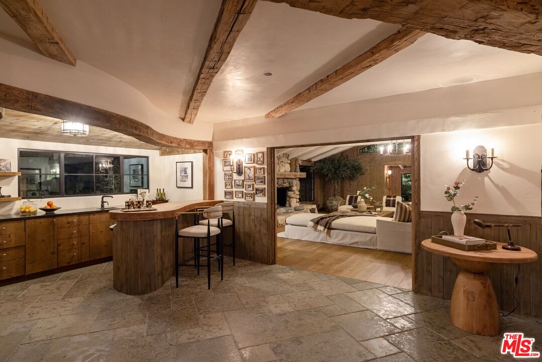3099 Mandeville Canyon Road Los Angeles, CA 90049 - Photo 7 of 50 a view of a patio with dining table and chairs