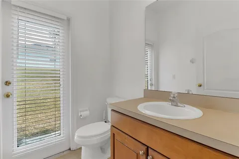 a view of an empty room with a window and closet