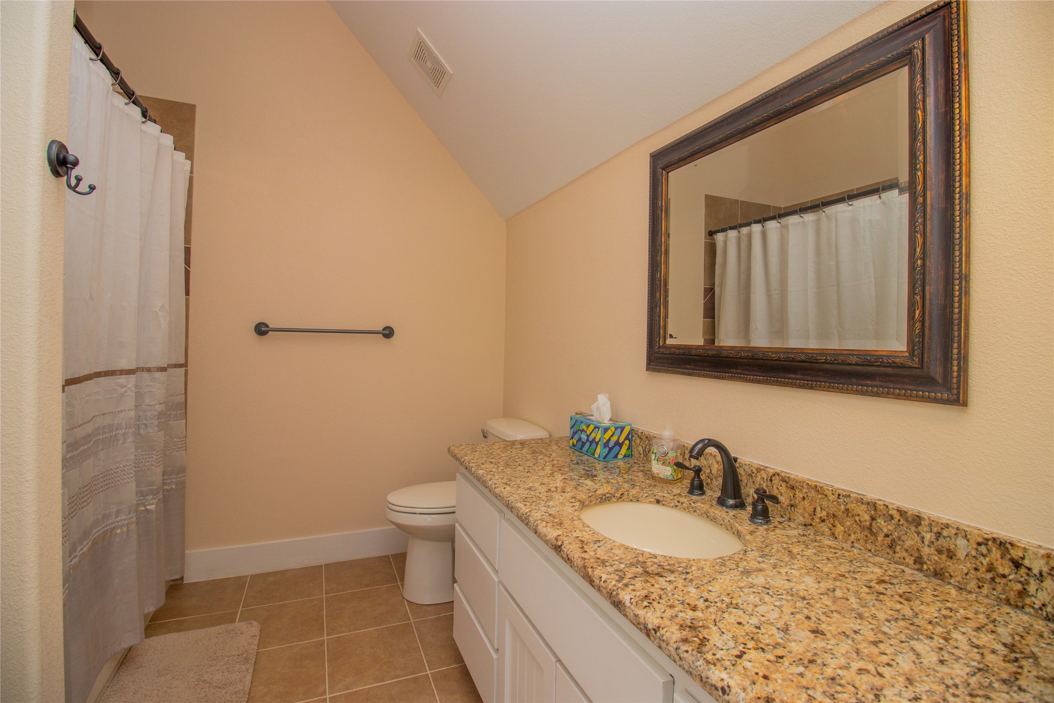 4237 County Road 330 Burnet, TX 78611 - Photo 21 of 40 a bathroom with a granite countertop sink toilet and shower