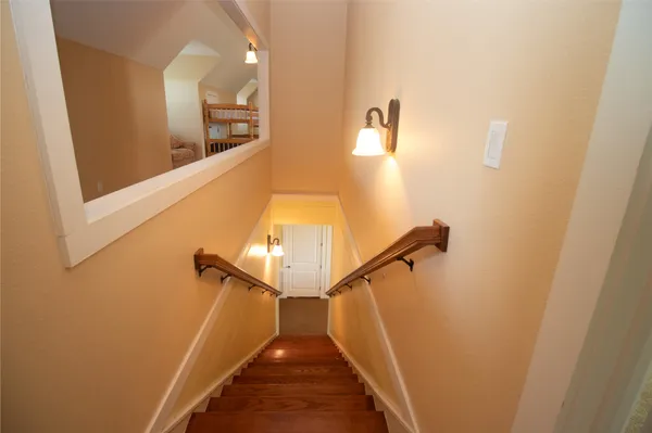 a bathroom with a granite countertop sink mirror vanity and toilet