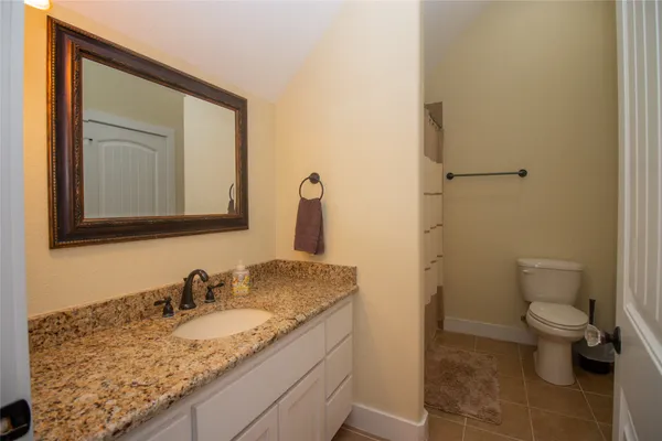 a view of a chairs and table in patio with a lake view