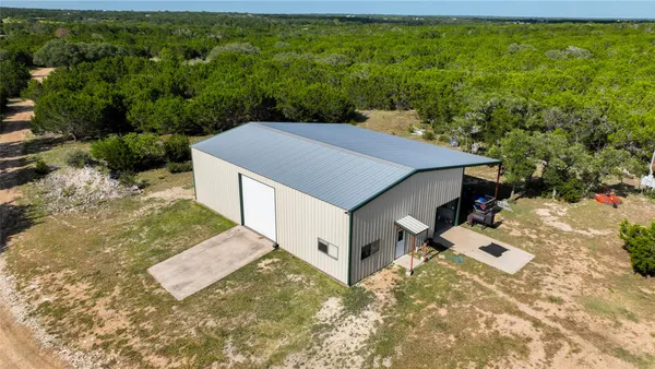 an aerial view of a house with a yard and plants