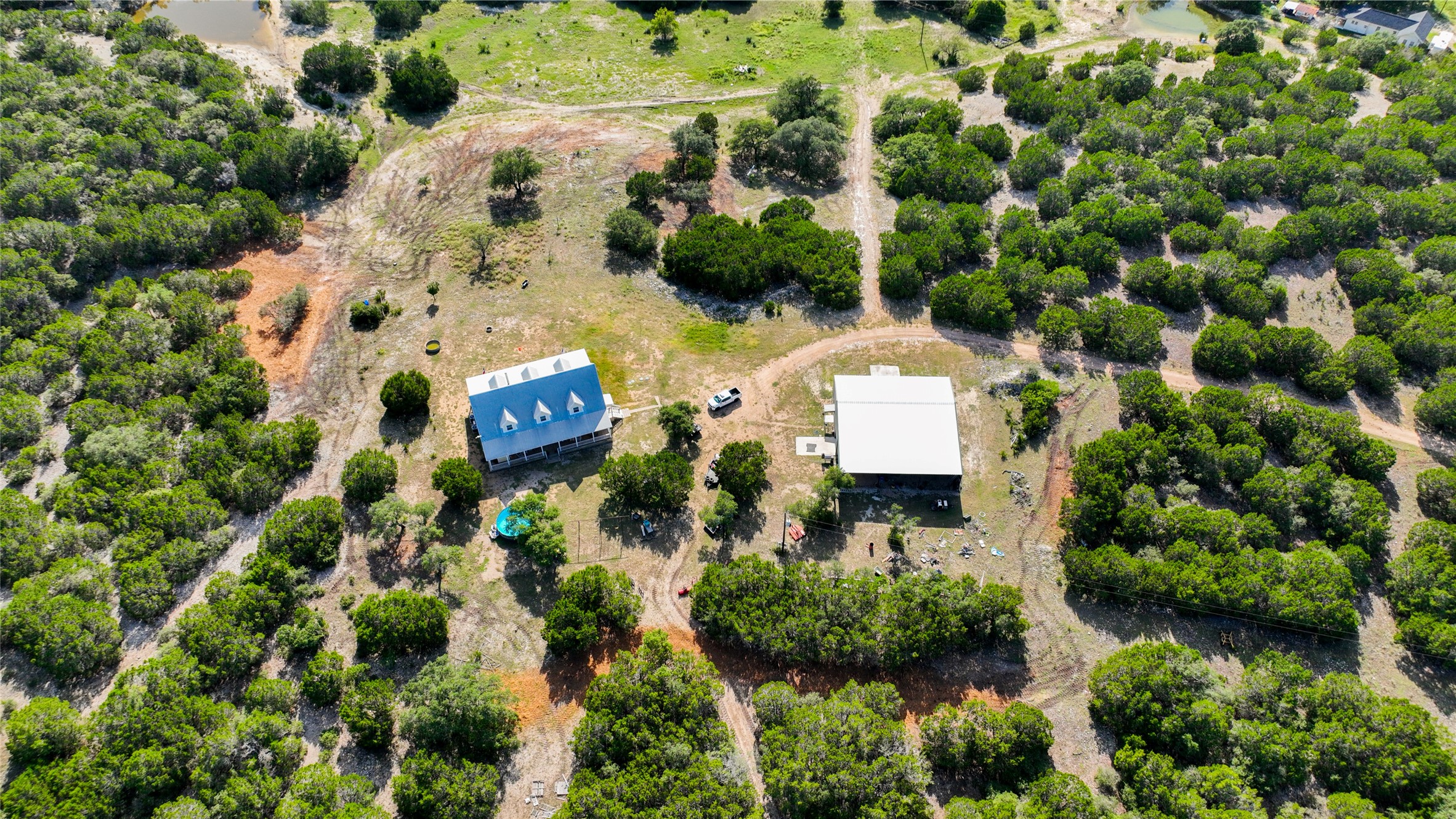 4237 County Road 330 Burnet, TX 78611 - Photo 39 of 40 an aerial view of a house with a yard and plants