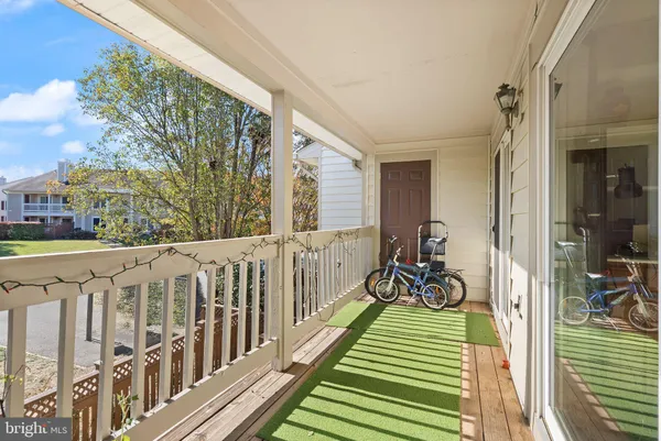 a view of a porch with wooden floor and fence