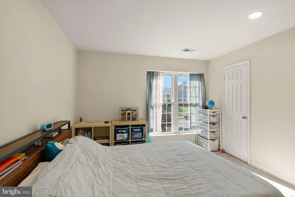 a bed room with a bed and a window