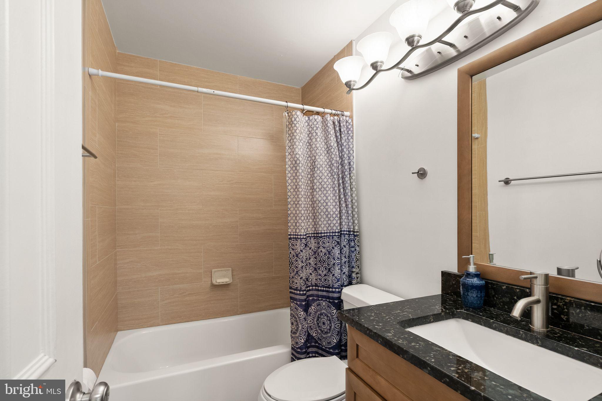 6905 Keyser Way Alexandria, VA 22310 - Photo 24 of 50 a bathroom with a granite countertop sink toilet and shower