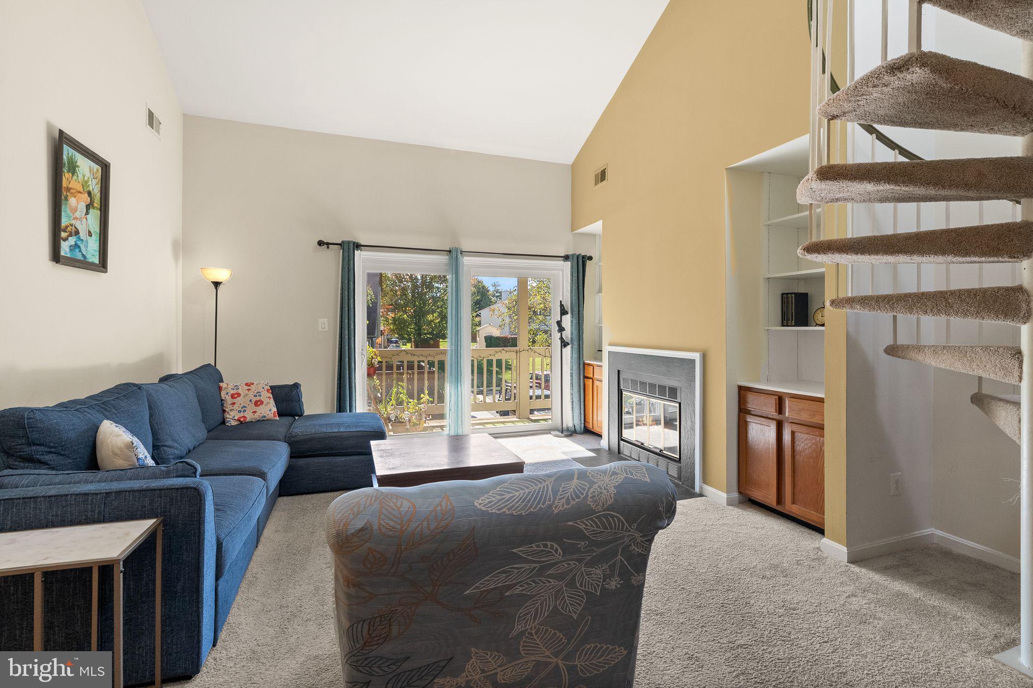 6905 Keyser Way Alexandria, VA 22310 - Photo 8 of 50 a living room with furniture a fireplace and a large window