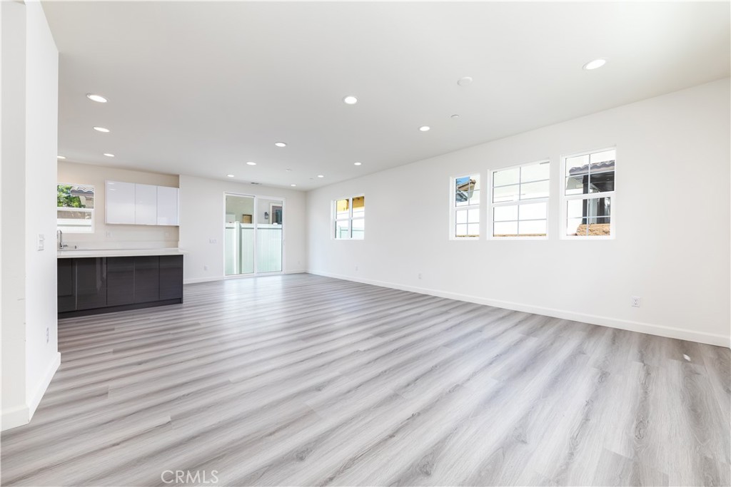 1371 Point Loma Place Walnut, CA 91789 - Photo 12 of 37 an empty room with wooden floor and windows
