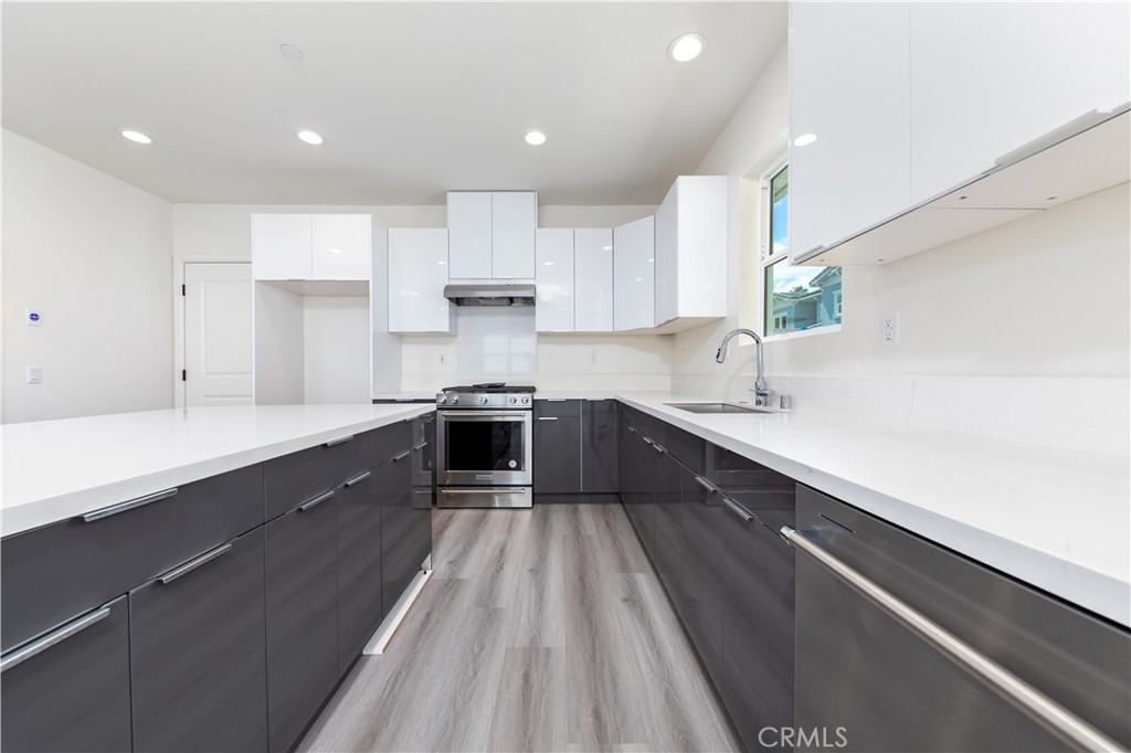 1371 Point Loma Place Walnut, CA 91789 - Photo 16 of 37 a large kitchen with a large counter top a sink stainless steel appliances and cabinets