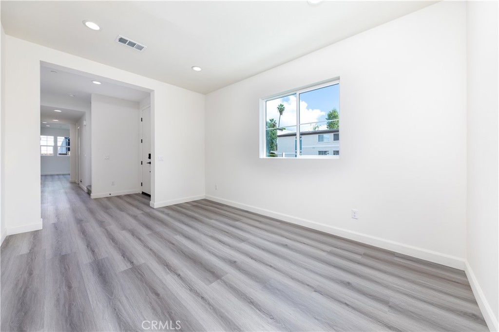1371 Point Loma Place Walnut, CA 91789 - Photo 7 of 37 an empty room with wooden floor and windows