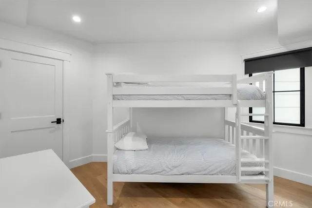 a room with a wooden floor and white walls