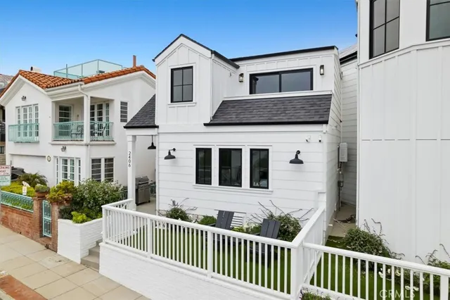 a front view of a house with a fence