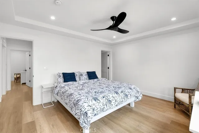 a bedroom with a bed and a ceiling fan