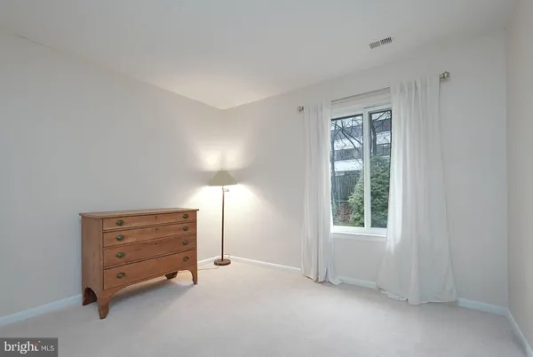 a view of patio with a table and chairs and floor to ceiling window