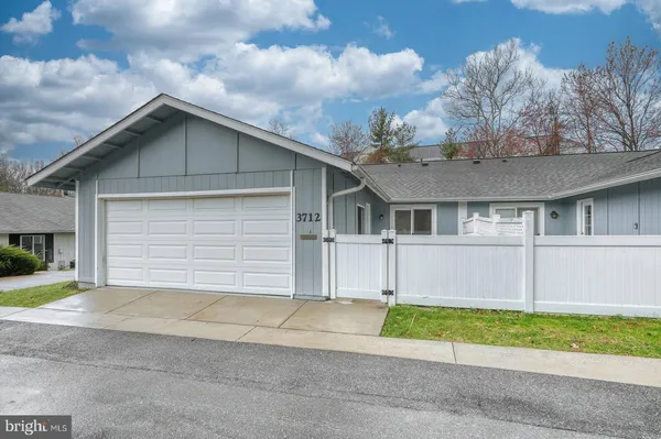 a front view of a house with a garden and yard