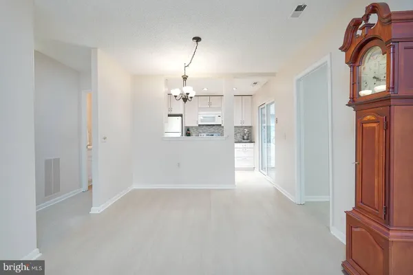 a view of a kitchen with a sink and refrigerator kitchen view