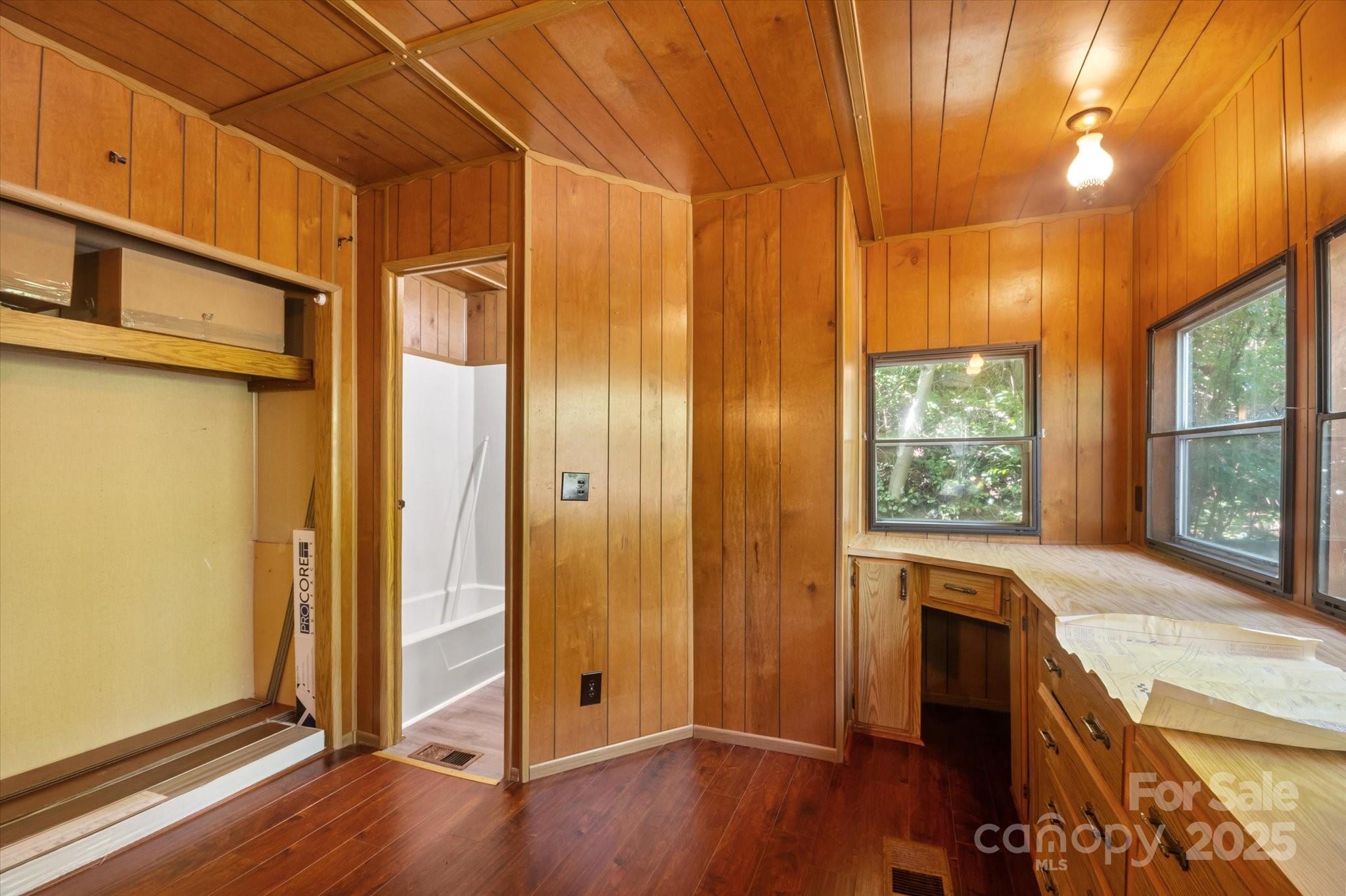 7 Maple Drive Brevard, NC 28712 - Photo 11 of 31 an empty room with wooden floor and windows