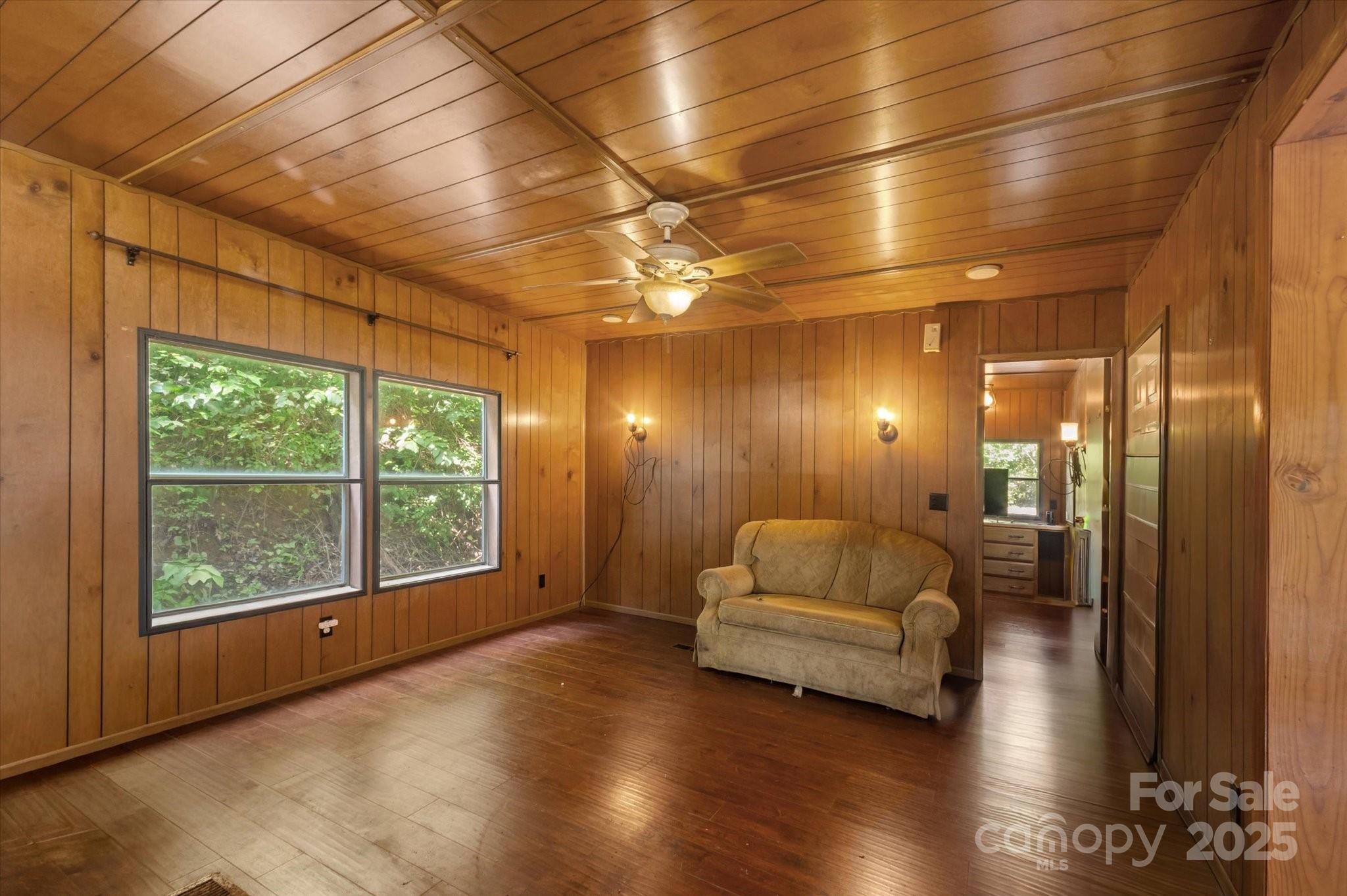7 Maple Drive Brevard, NC 28712 - Photo 17 of 31 a hallway with a couch and a large window with wooden floor
