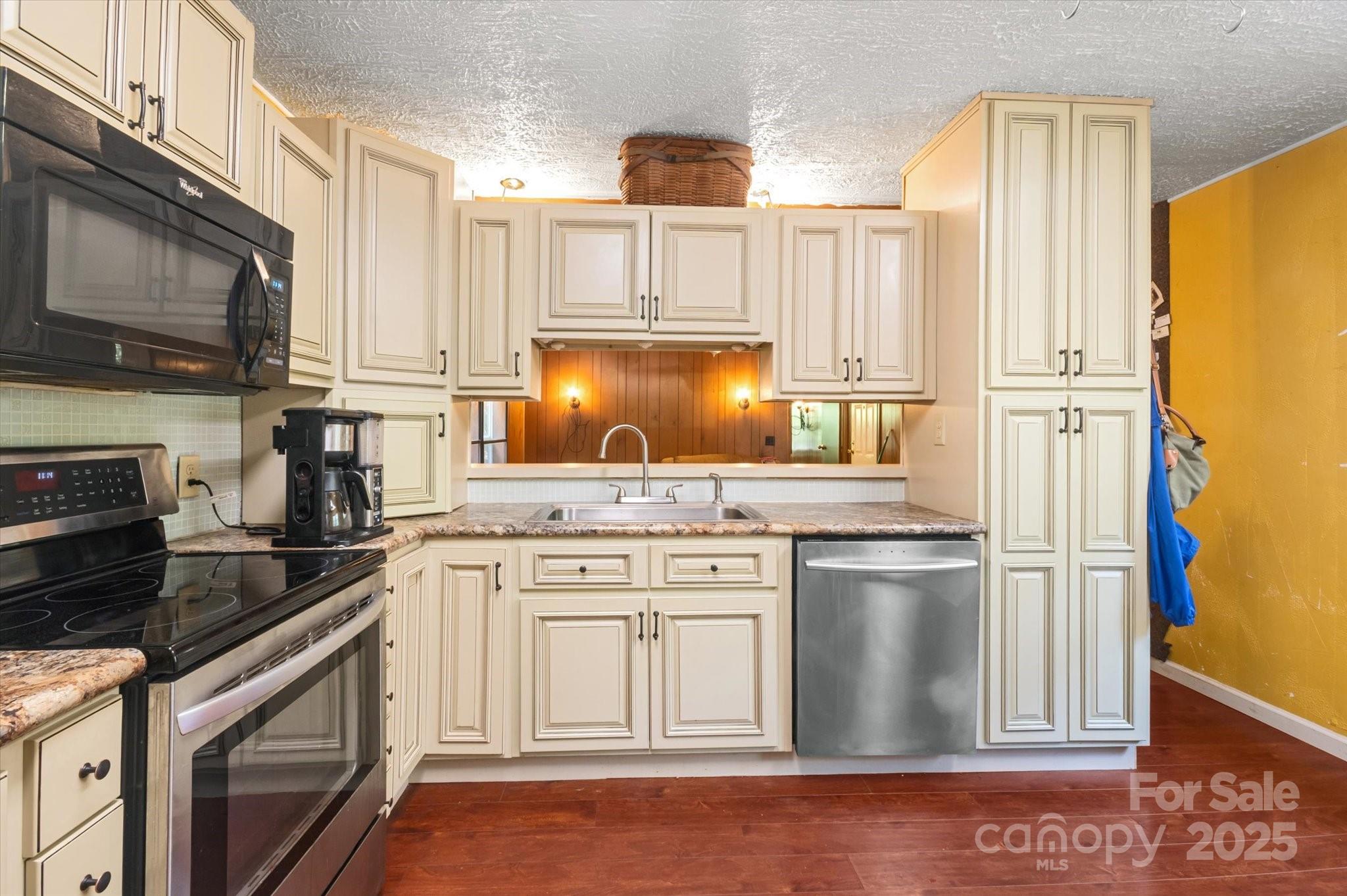 7 Maple Drive Brevard, NC 28712 - Photo 18 of 31 a kitchen with stainless steel appliances granite countertop a stove a sink and a refrigerator