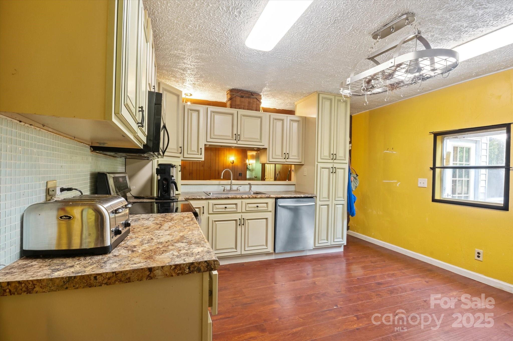 7 Maple Drive Brevard, NC 28712 - Photo 19 of 31 a kitchen with granite countertop counter top space a sink stainless steel appliances and cabinets